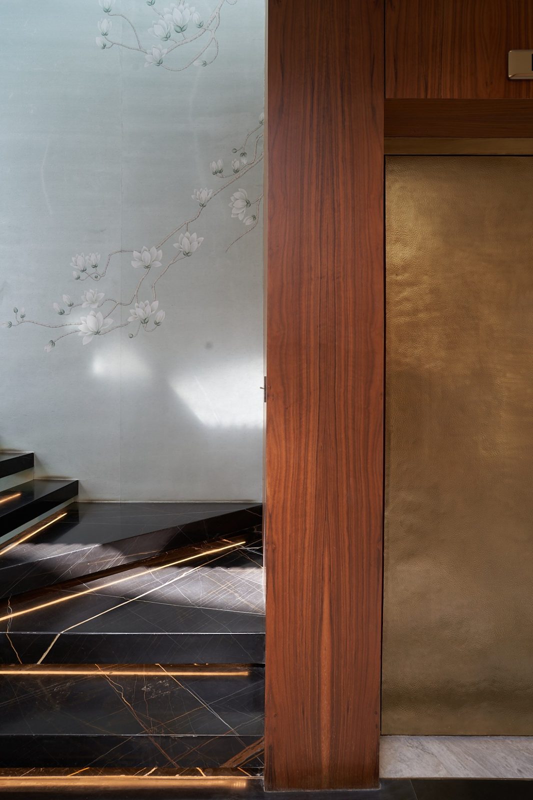 Habillage mural en placage noyer et encadrement d'ascenseur sur mesure, AMARGUS Contract